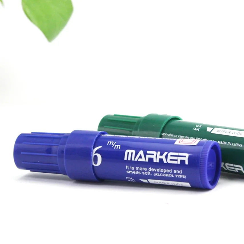 Art supplies including a marker pen on a table.