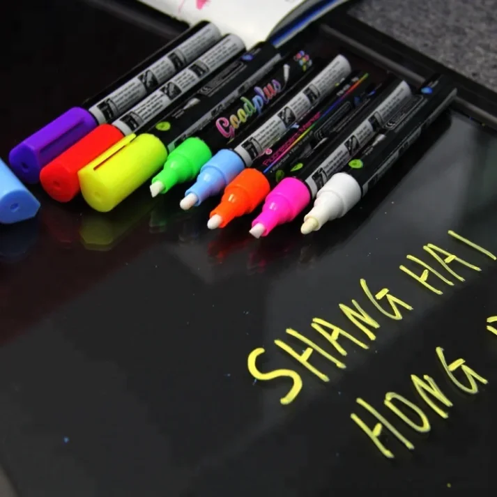 Sketch markers and other art supplies on a desk