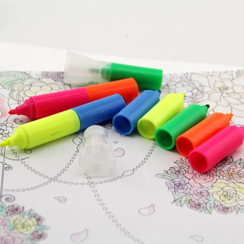Ink refill bottle and marker pen on a table.