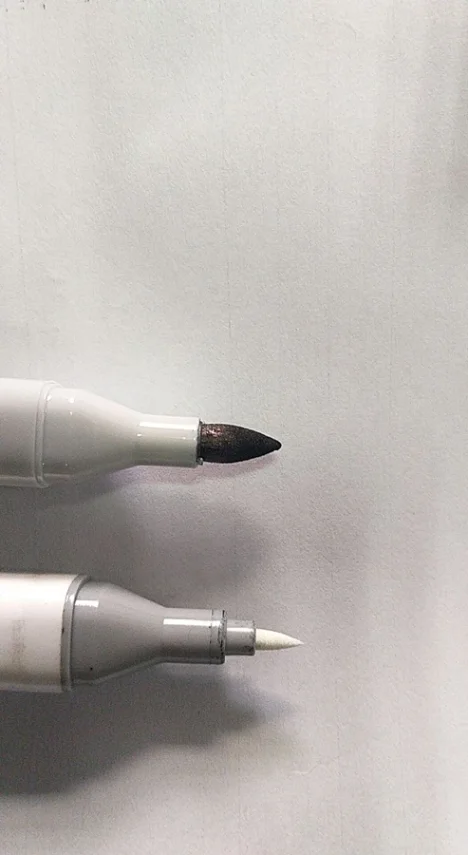 Close-up detail of a marker pen tip and ink flow.