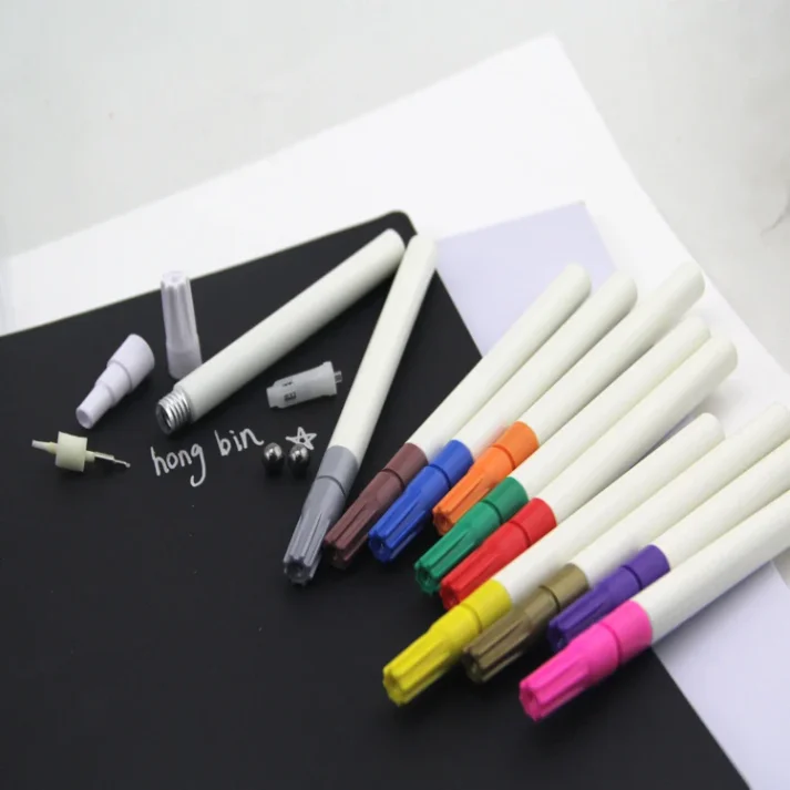 Sketch markers and other art supplies on a desk